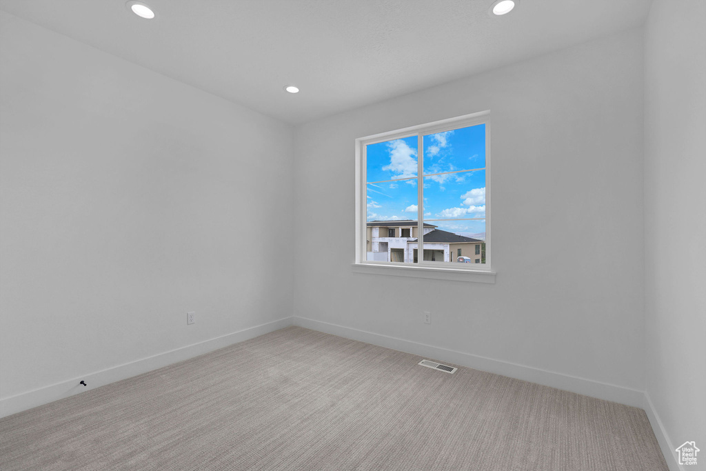 Spare room with baseboards, carpet, and recessed lighting
