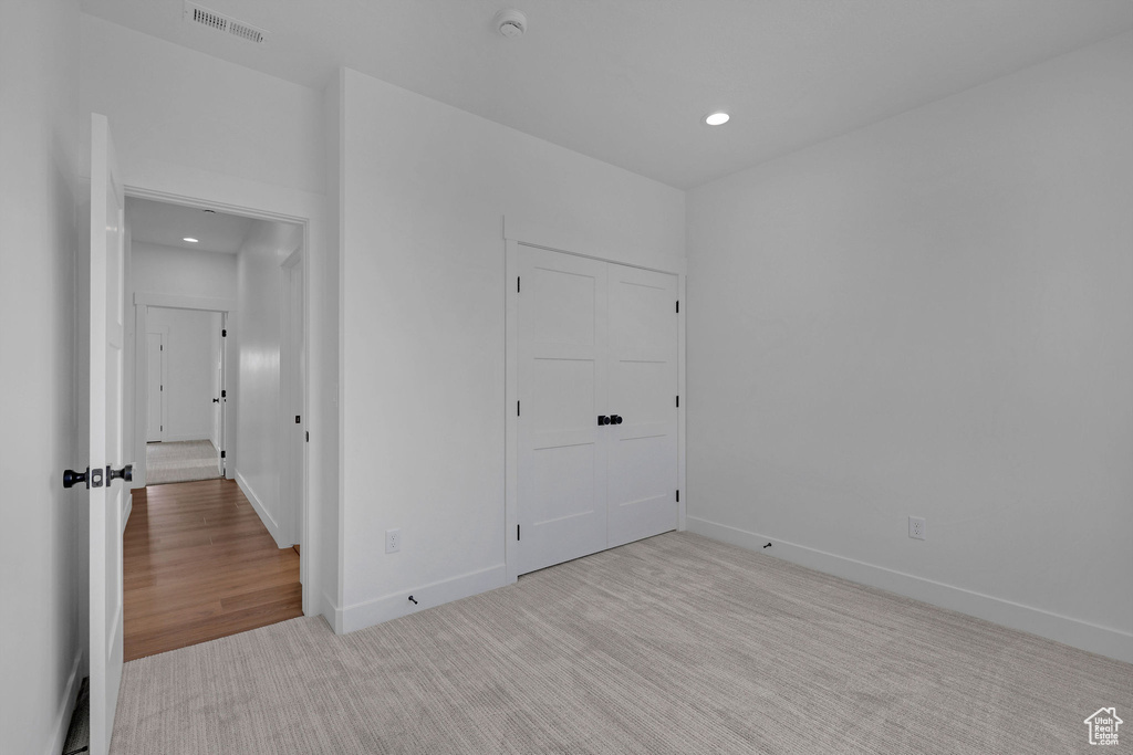 Unfurnished bedroom with recessed lighting, baseboards, and carpet