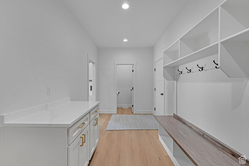 Mudroom with recessed lighting and light wood-type flooring