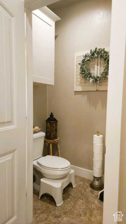 Bathroom featuring toilet and baseboards