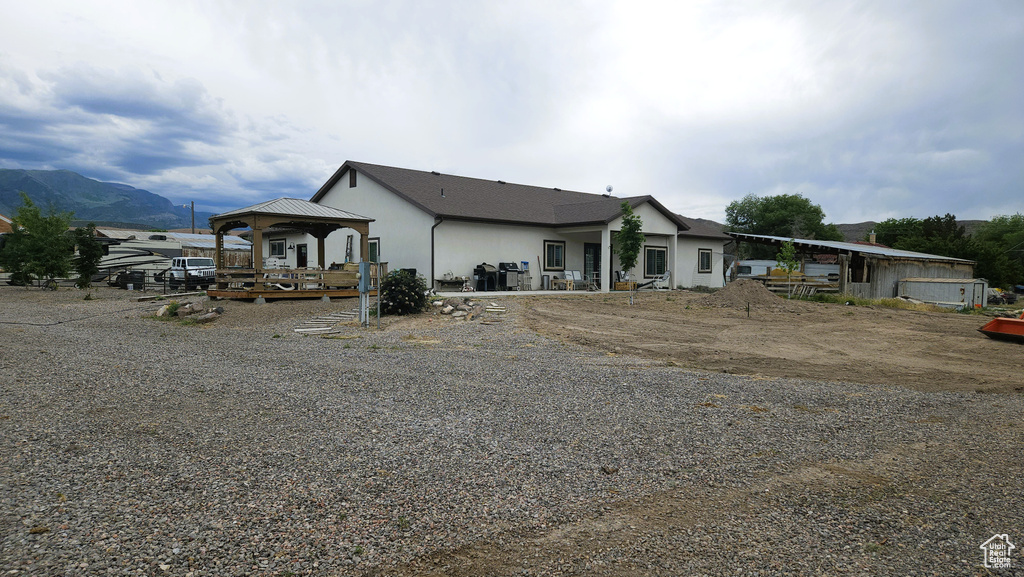 View of front facade with a gazebo and stucco siding