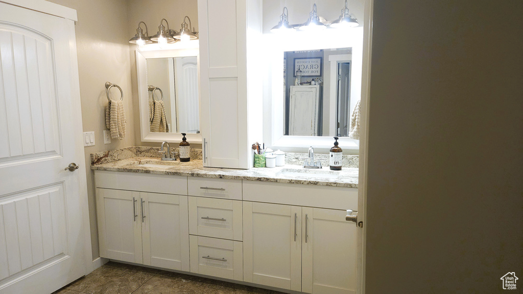 Bathroom featuring double vanity and tile patterned floors