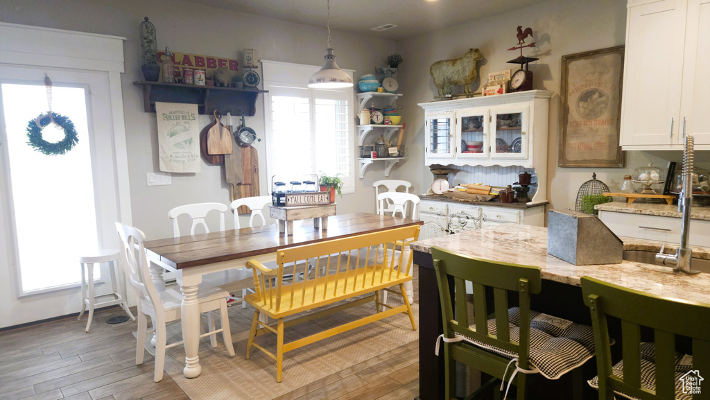 Dining room with healthy amount of natural light and light wood finished floors