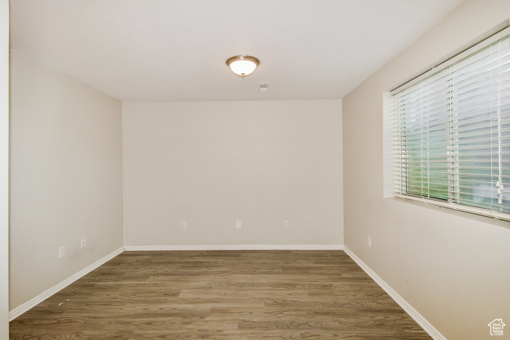 Spare room featuring wood finished floors and baseboards