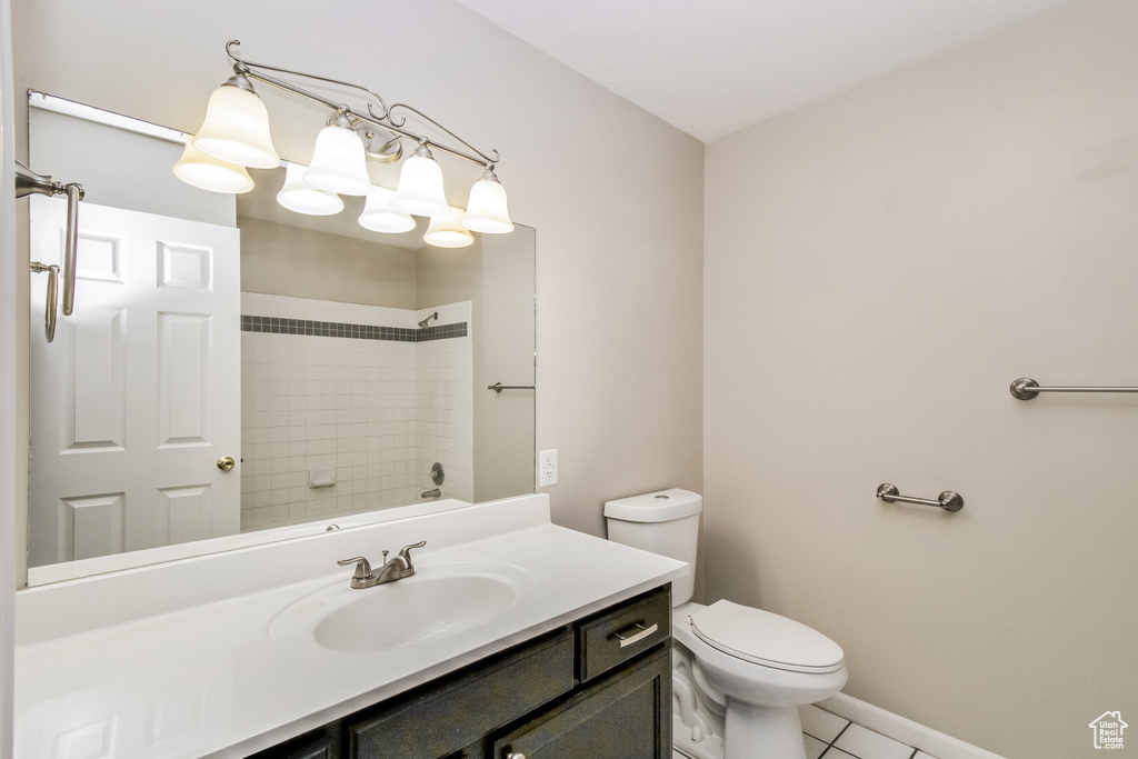 Bathroom with vanity, tile patterned flooring, toilet, and baseboards