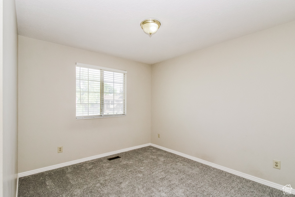 Spare room with carpet flooring and baseboards