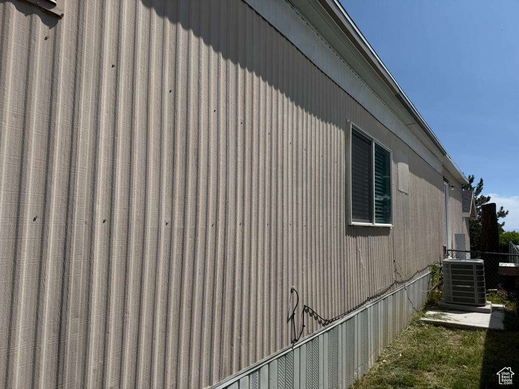 View of side of property with central AC unit