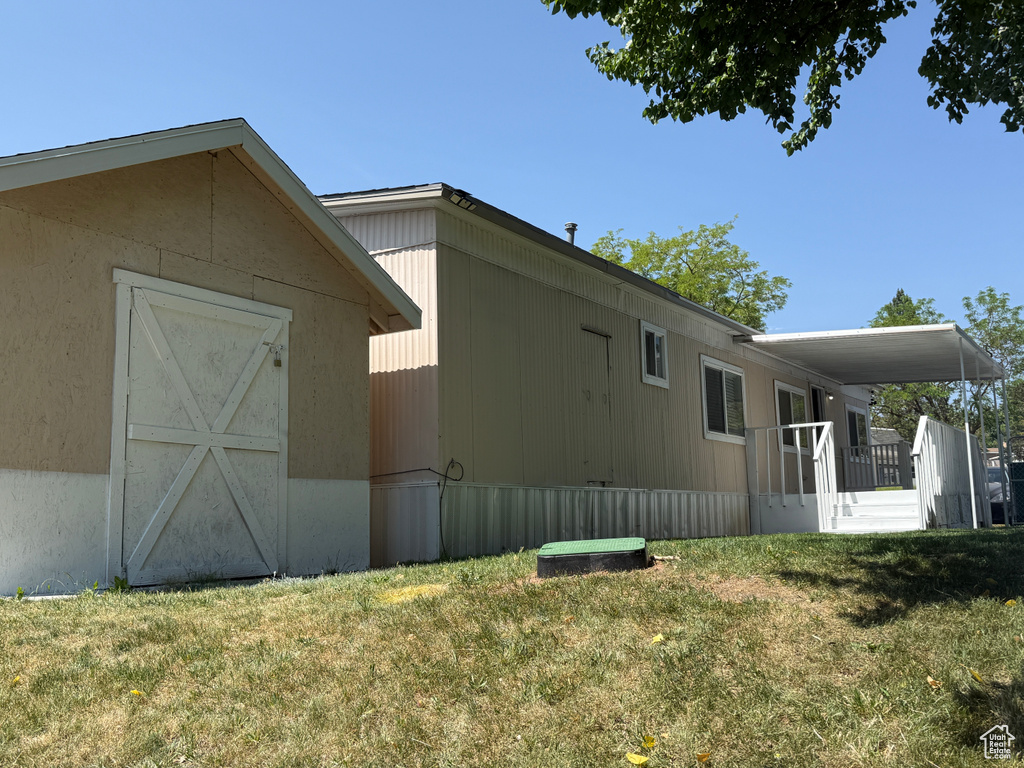 View of property exterior featuring a yard