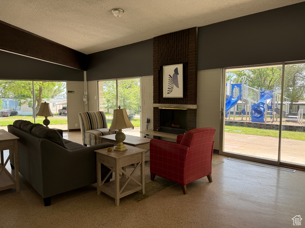 Living area featuring a textured ceiling and a fireplace