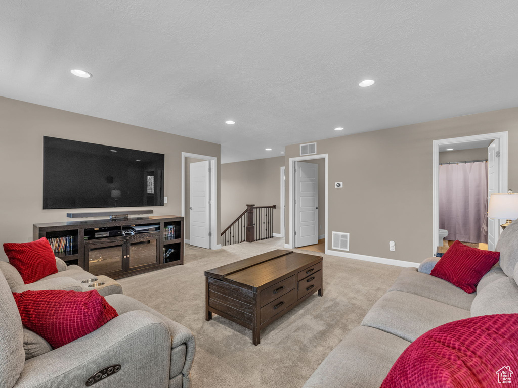 Living area featuring recessed lighting, carpet flooring, and baseboards