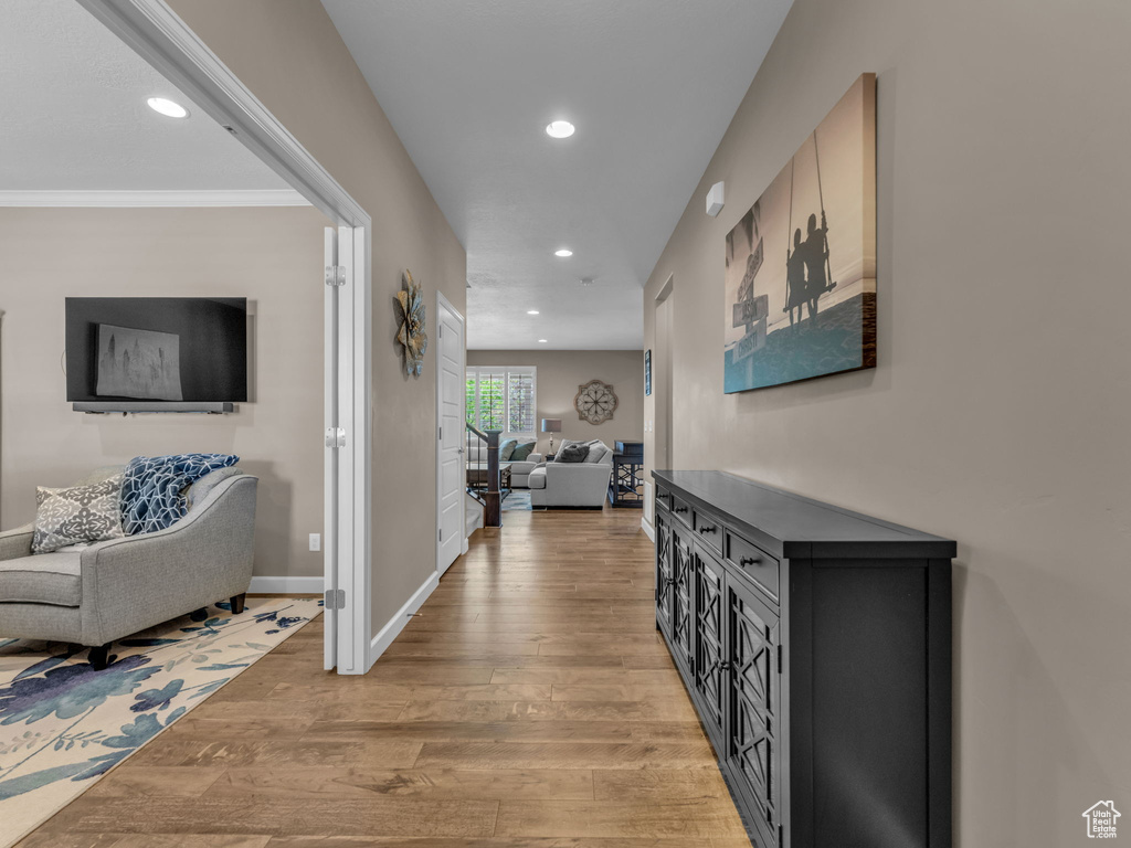 Corridor featuring light wood-style flooring, recessed lighting, and baseboards