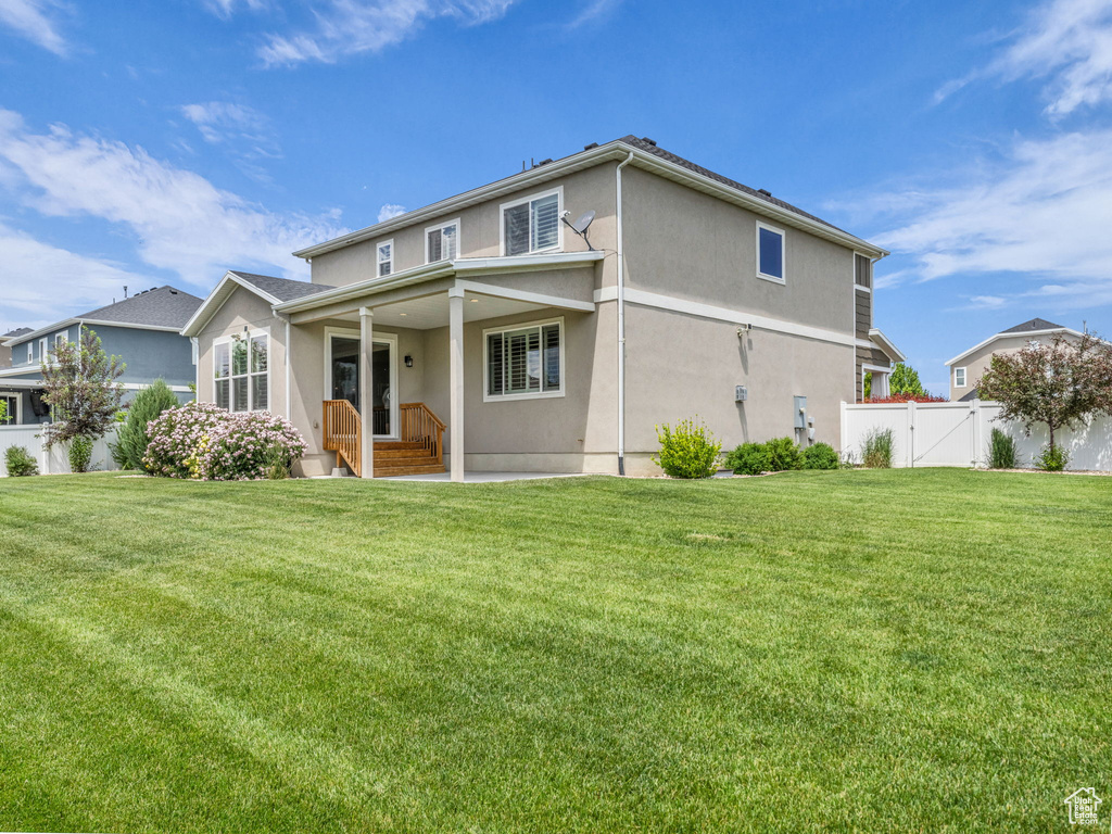 Back of property featuring a gate and stucco siding