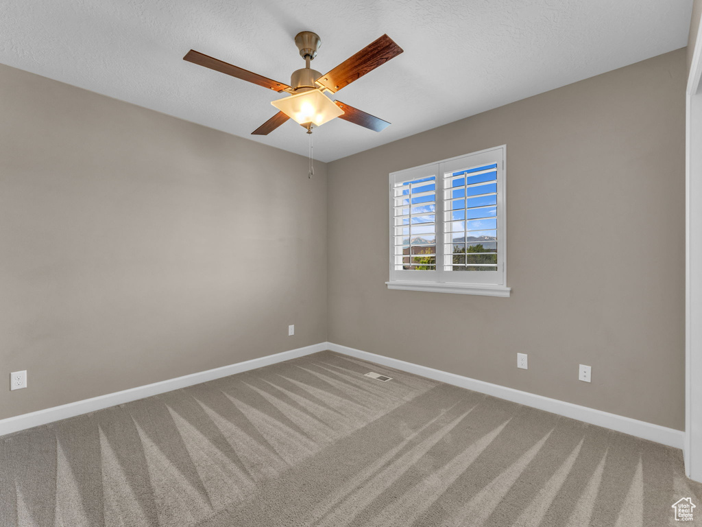 Empty room with carpet flooring and baseboards