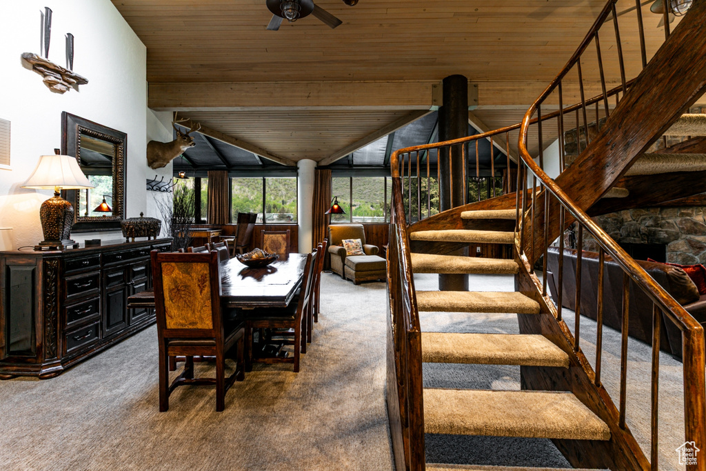 Dining room with carpet flooring, wooden ceiling, stairway, and ceiling fan
