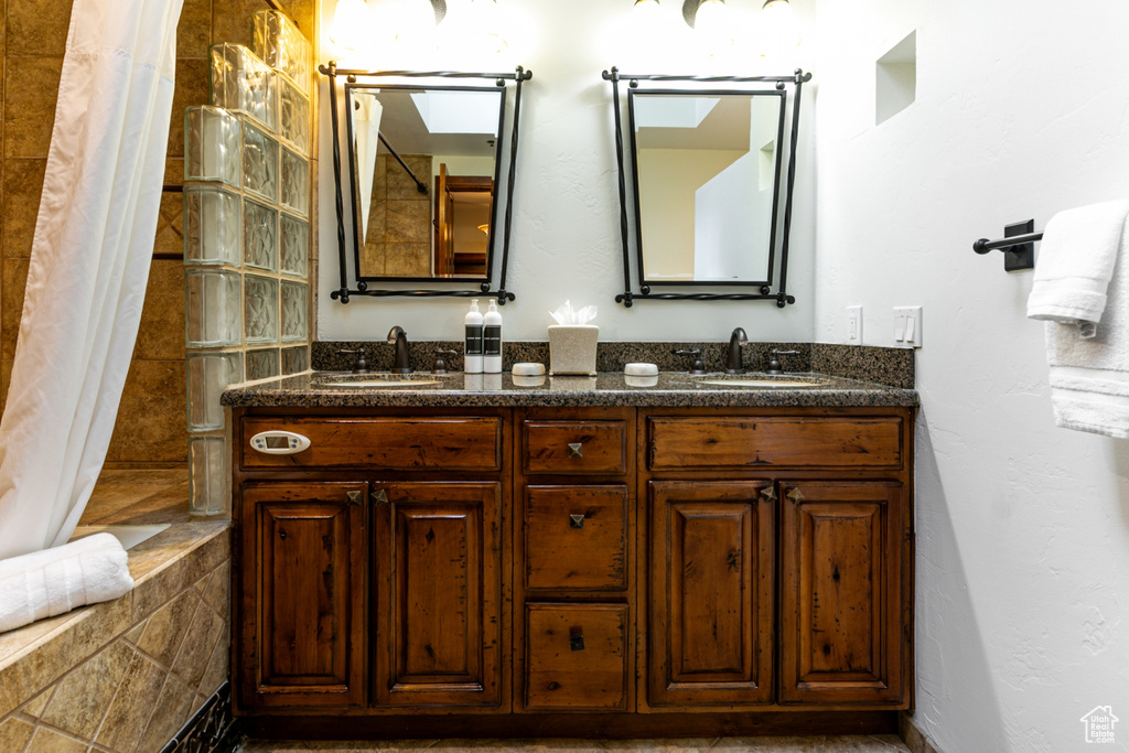 Full bath featuring double vanity
