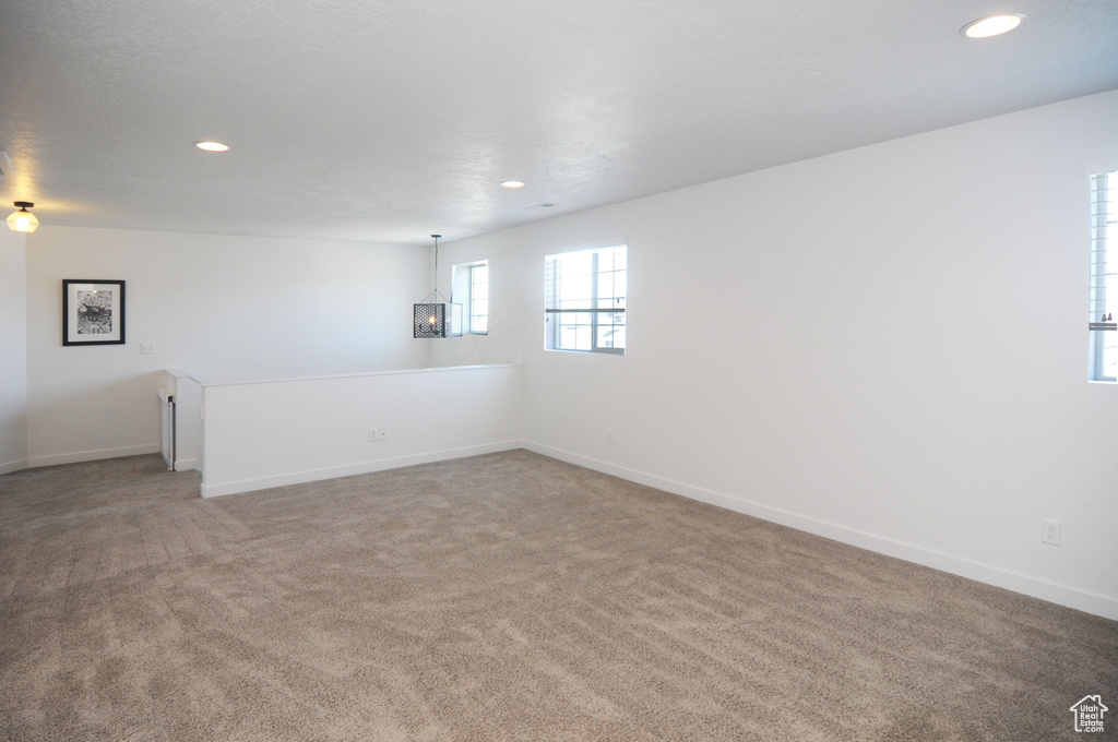 Unfurnished room featuring light carpet, recessed lighting, and baseboards