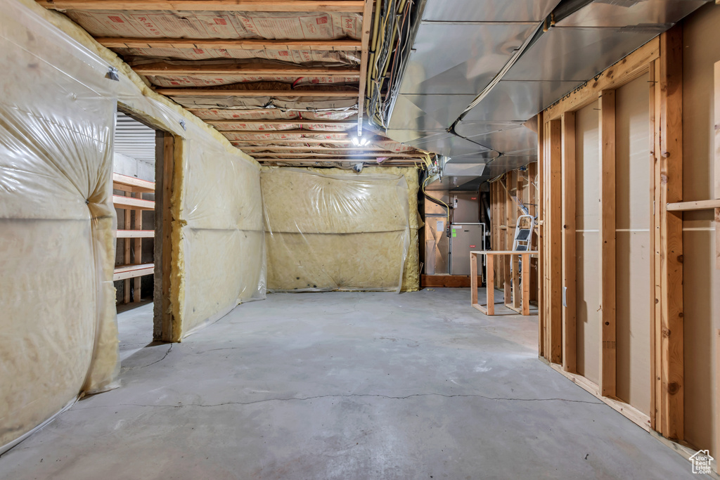 Unfinished below grade area with heating unit