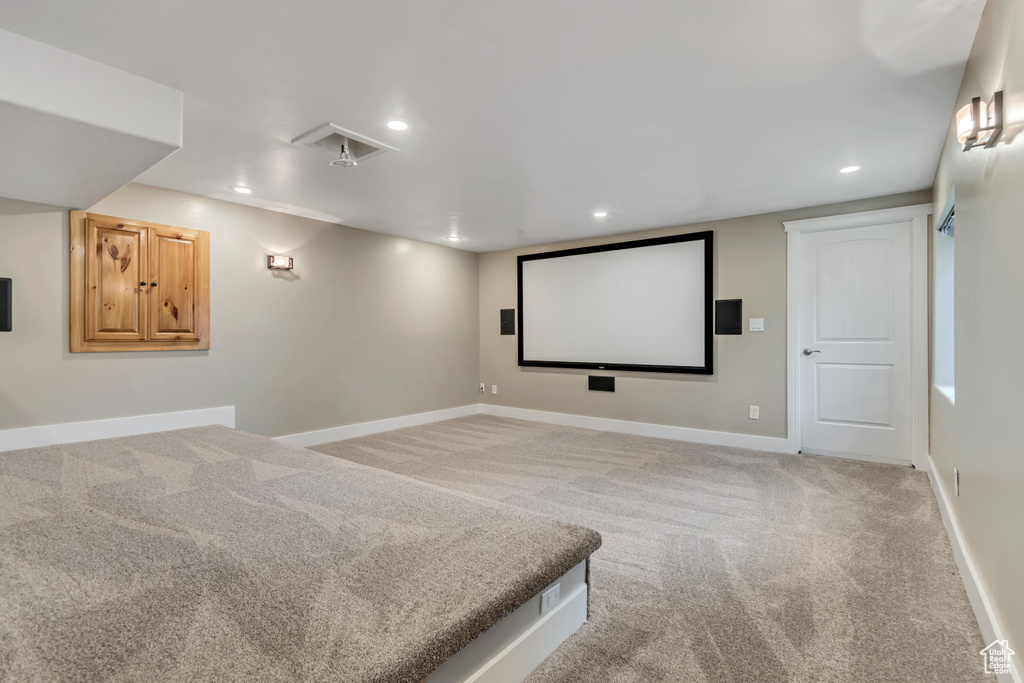 Cinema with light carpet, baseboards, and recessed lighting