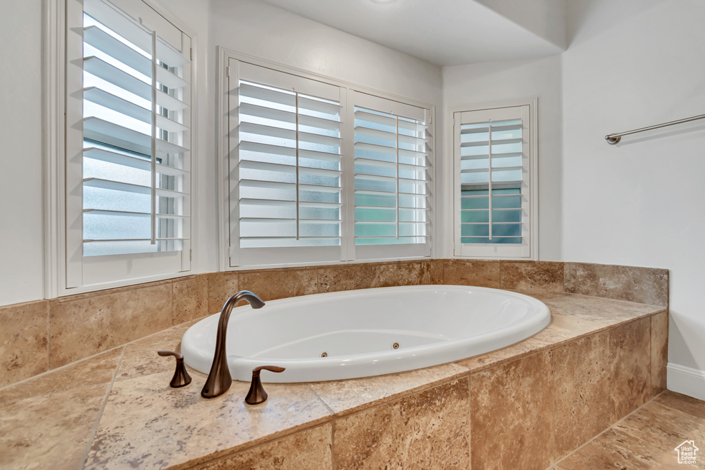 Full bathroom featuring a tub with jets