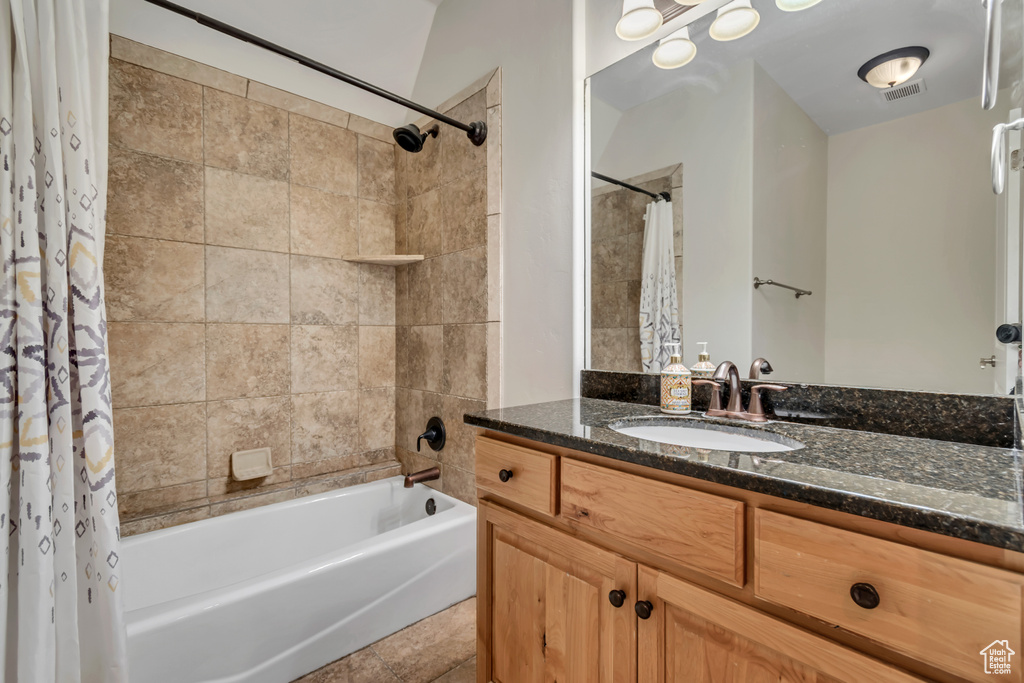 Bathroom featuring shower / tub combo with curtain, vanity, and tile patterned flooring