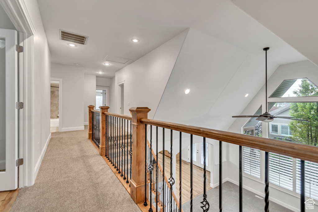 Corridor with baseboards, recessed lighting, an upstairs landing, and light colored carpet