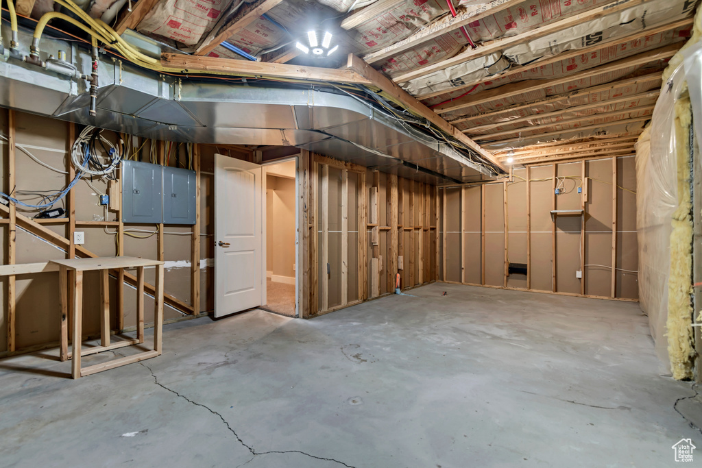 Unfinished basement with electric panel