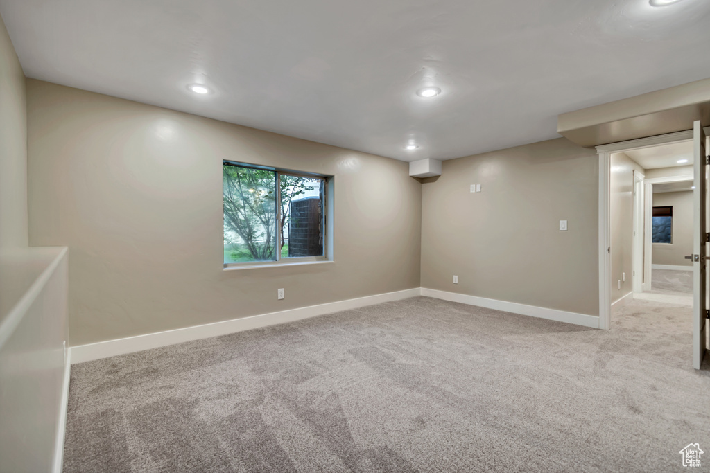 Carpeted empty room with baseboards and recessed lighting