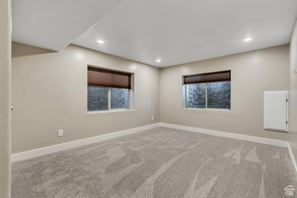 Unfurnished room featuring baseboards, carpet, and recessed lighting