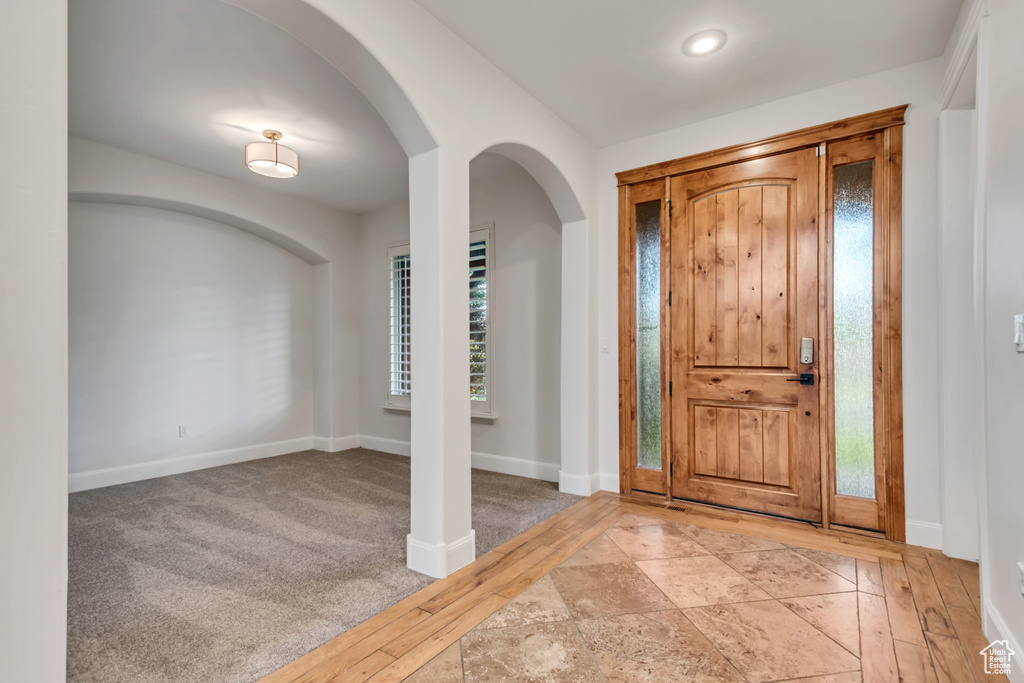 Entryway featuring arched walkways and baseboards