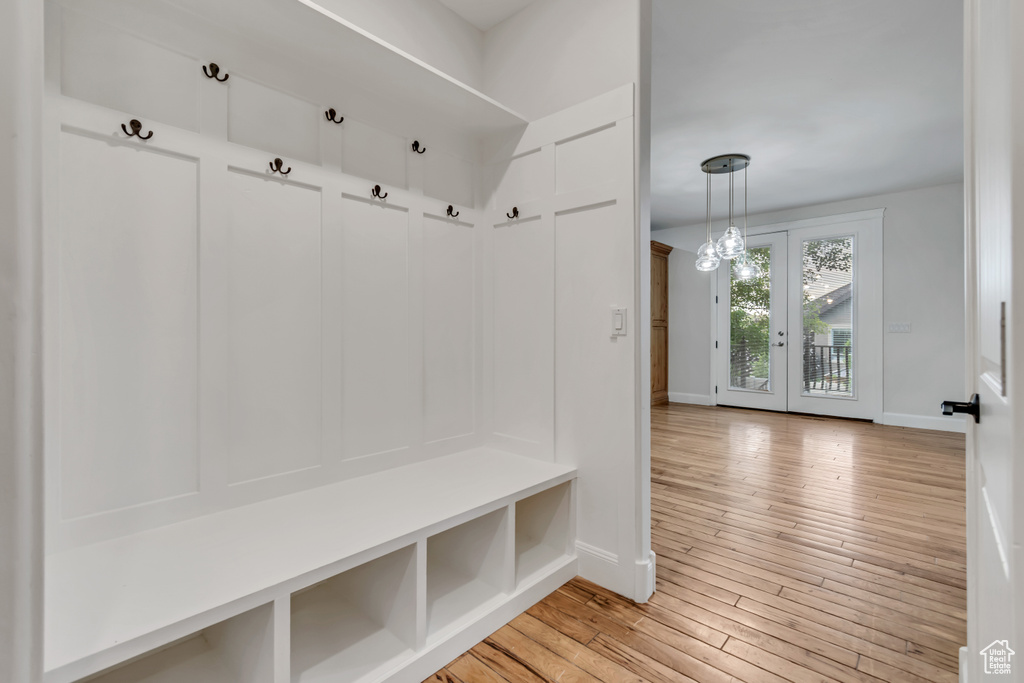 Mudroom with baseboards, light wood-type flooring, and french doors