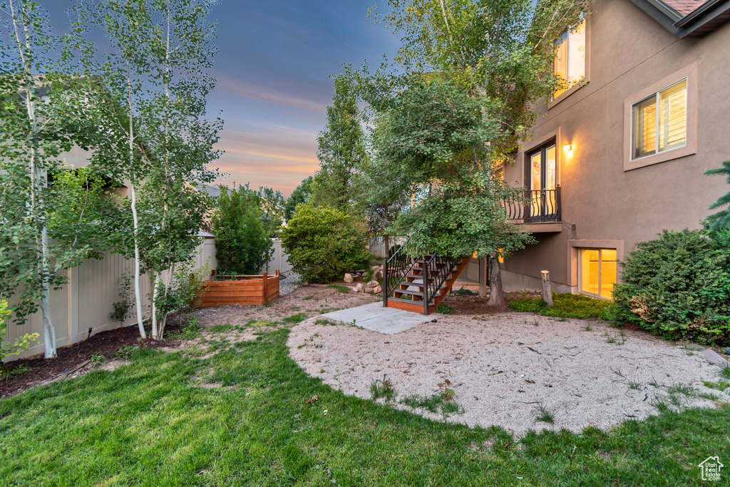 View of yard featuring stairs and a vegetable garden