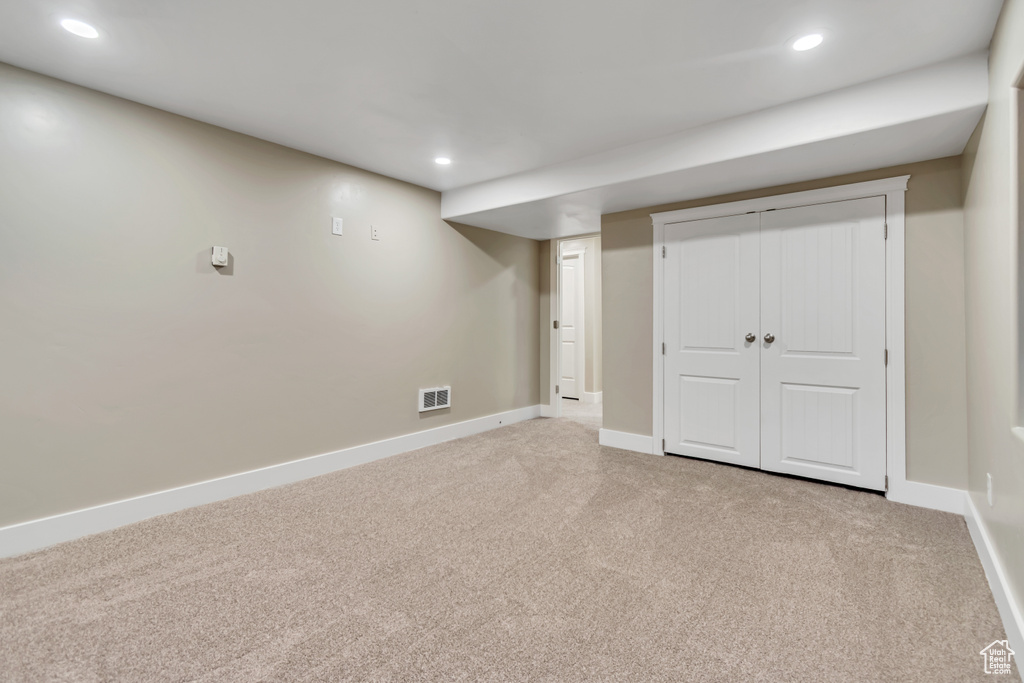Finished below grade area featuring carpet, baseboards, and recessed lighting