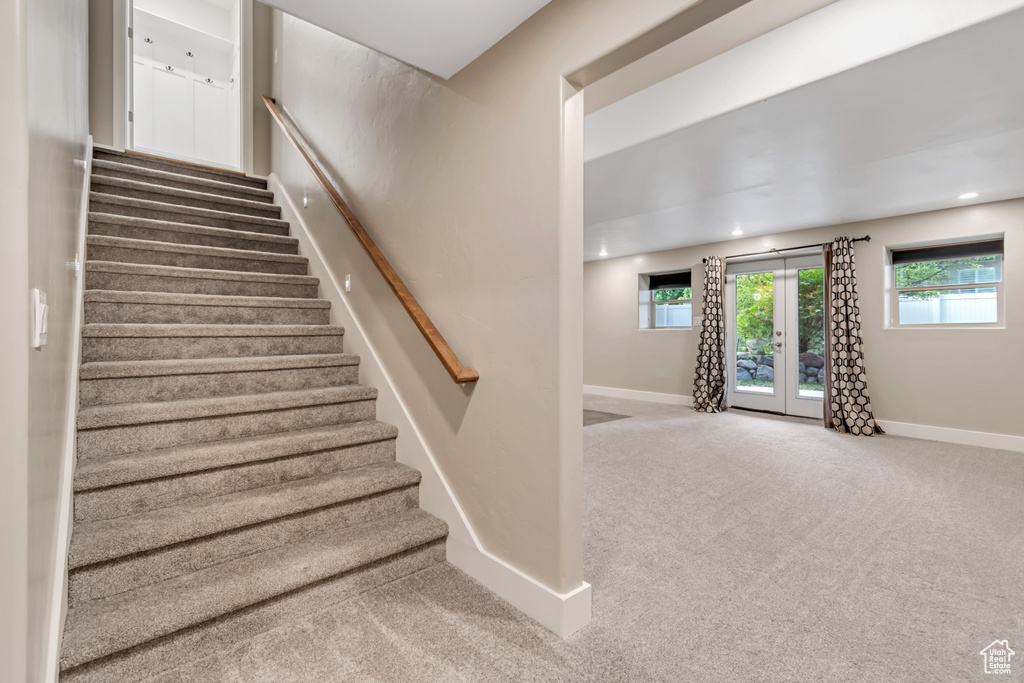 Stairs with baseboards, carpet flooring, french doors, and recessed lighting