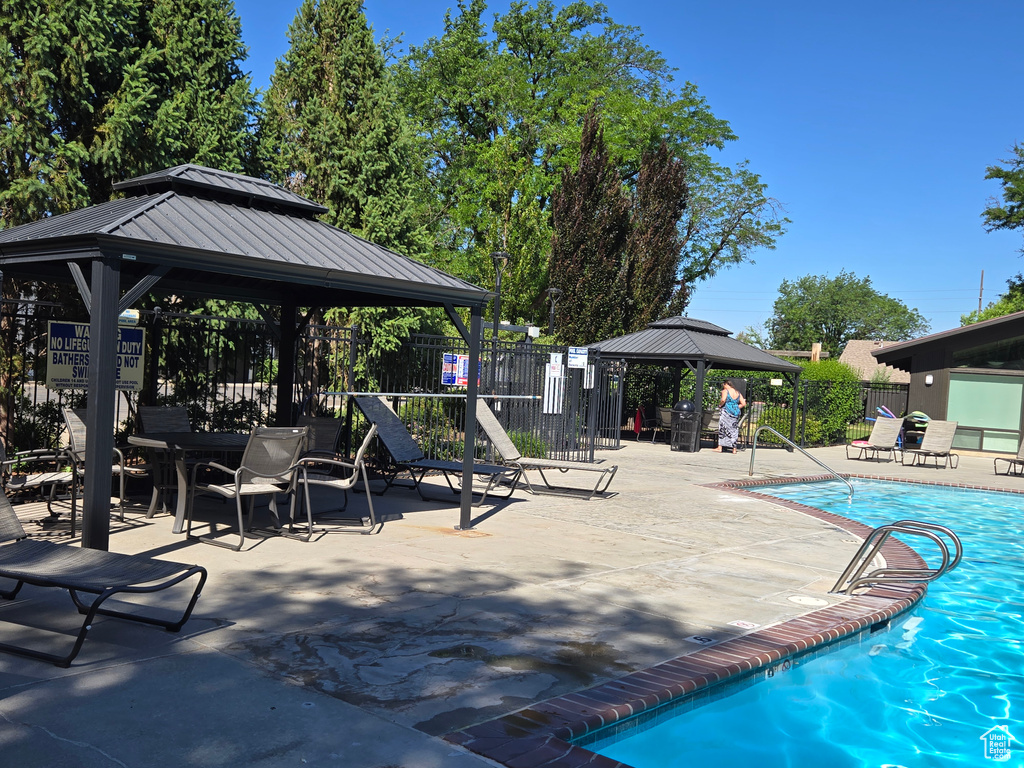 Community pool featuring a gazebo and a patio