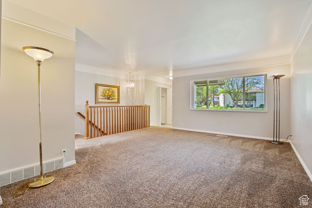 Unfurnished room with carpet flooring and baseboards