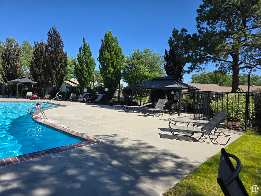 Community pool featuring a gazebo and a patio