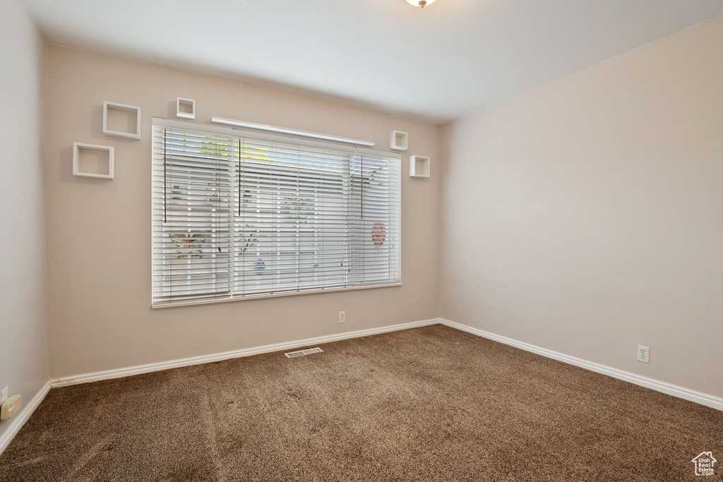 Unfurnished room featuring carpet flooring and baseboards