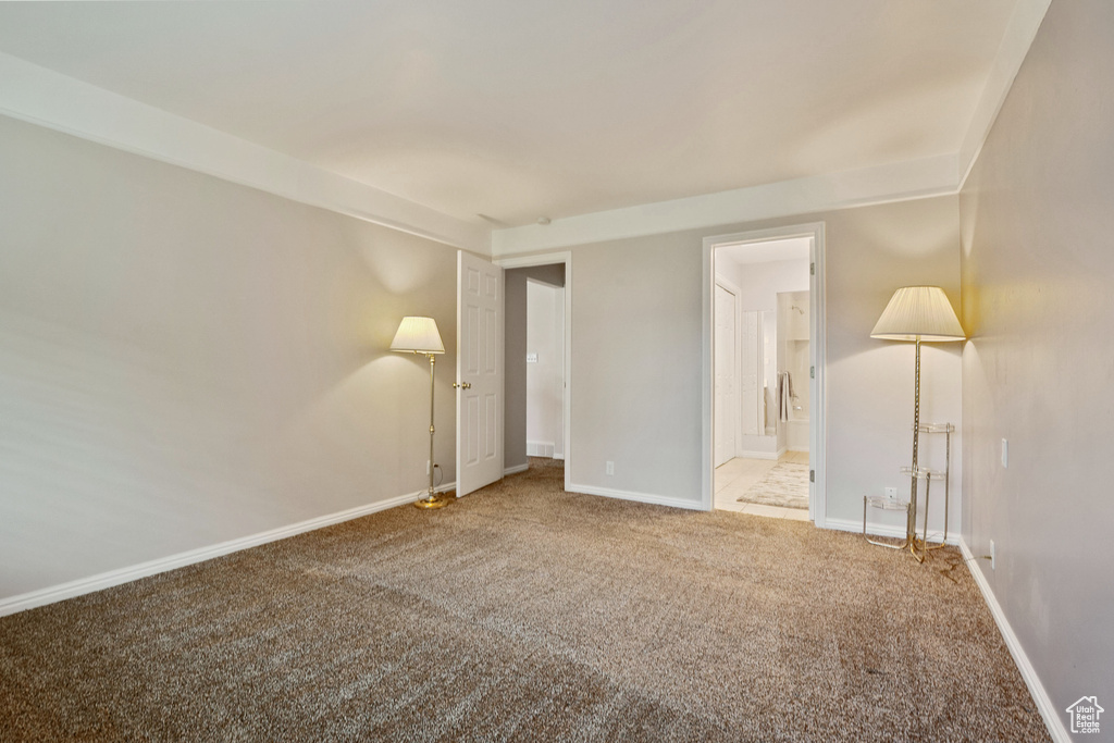 Unfurnished room with carpet flooring and baseboards