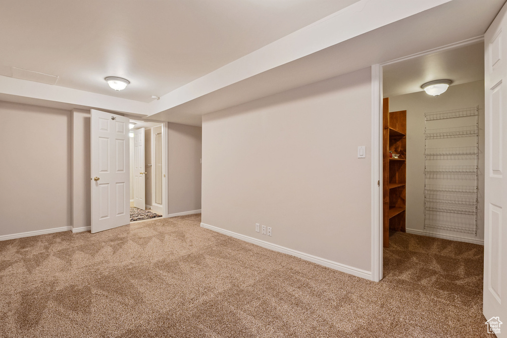 Unfurnished bedroom featuring carpet flooring and baseboards