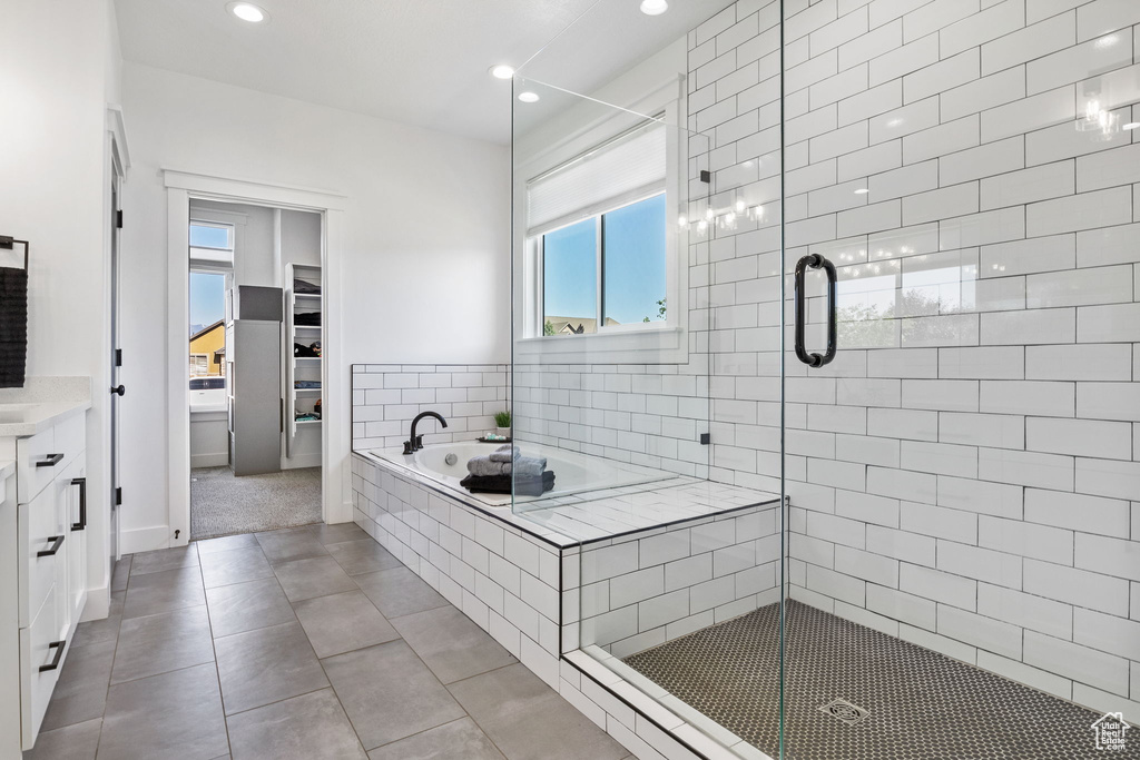 Full bath with plenty of natural light, tile patterned floors, a garden tub, a shower stall, and recessed lighting