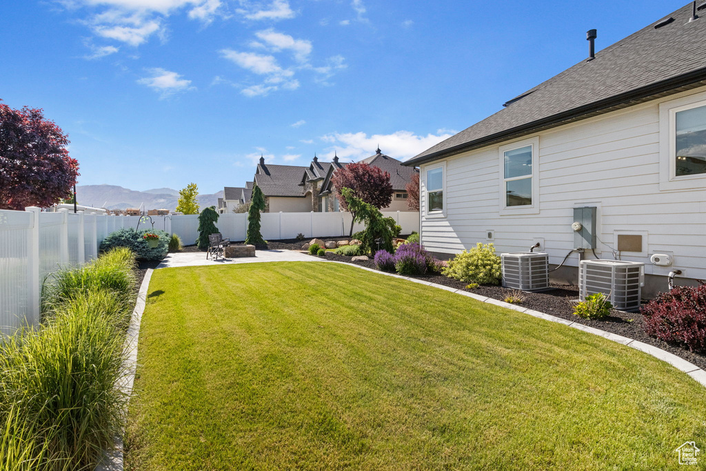 View of yard featuring central AC unit and a patio area