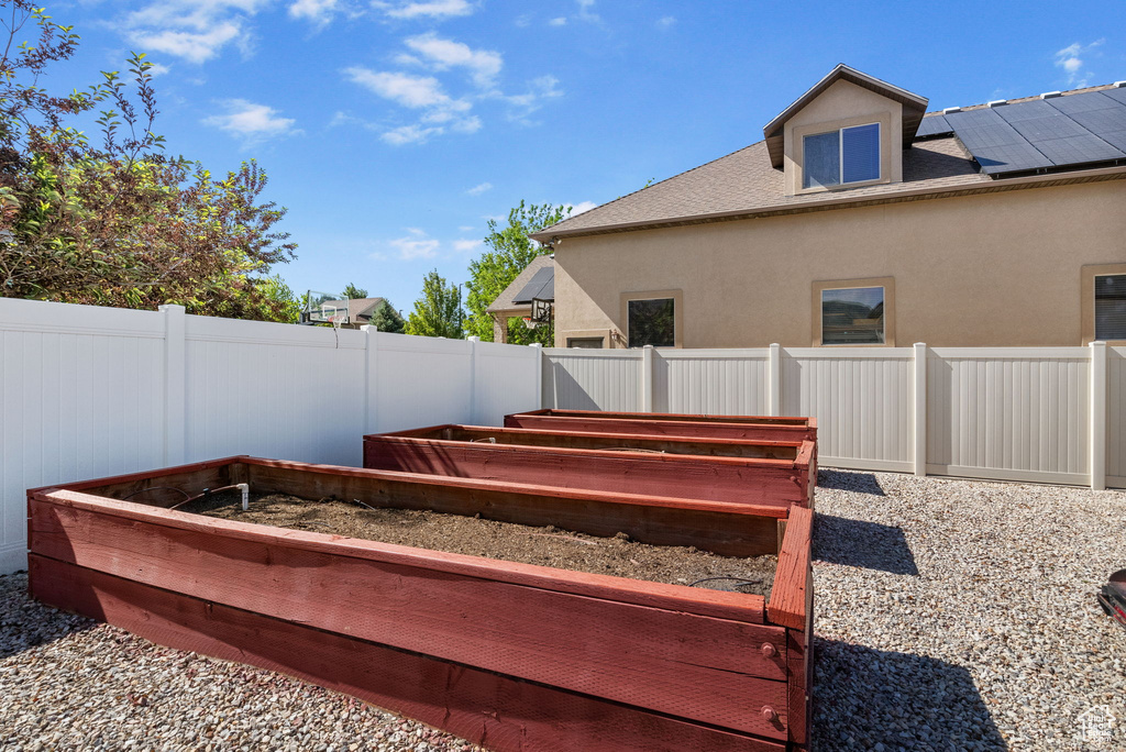 Fenced backyard with a vegetable garden