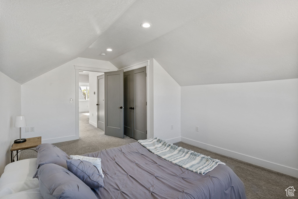 Bedroom featuring carpet floors, baseboards, vaulted ceiling, and recessed lighting