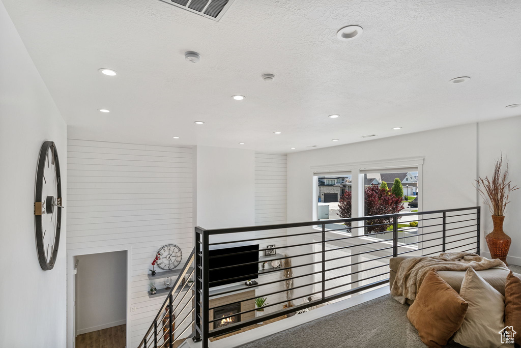 Corridor featuring an upstairs landing, recessed lighting, and baseboards