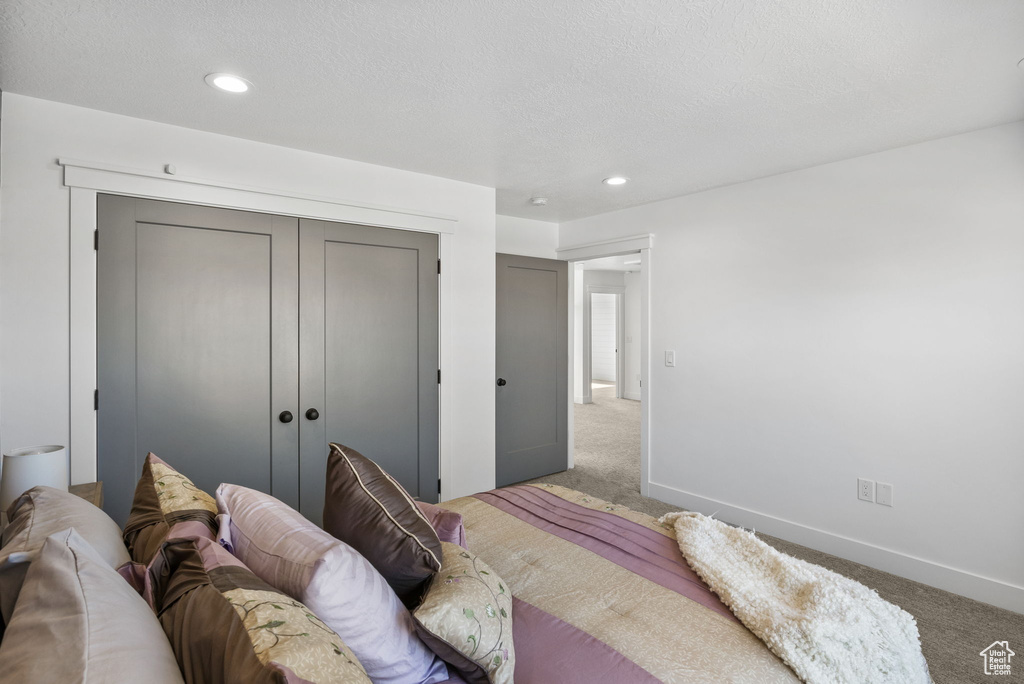 Bedroom with carpet, recessed lighting, a closet, and baseboards
