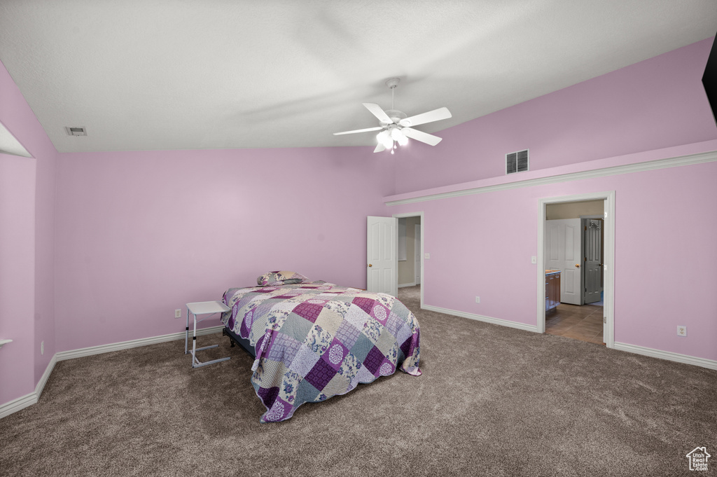 Bedroom with carpet floors, lofted ceiling, baseboards, and a ceiling fan