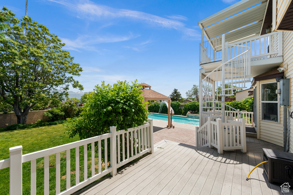 Deck featuring stairs, an outdoor pool, and a gazebo