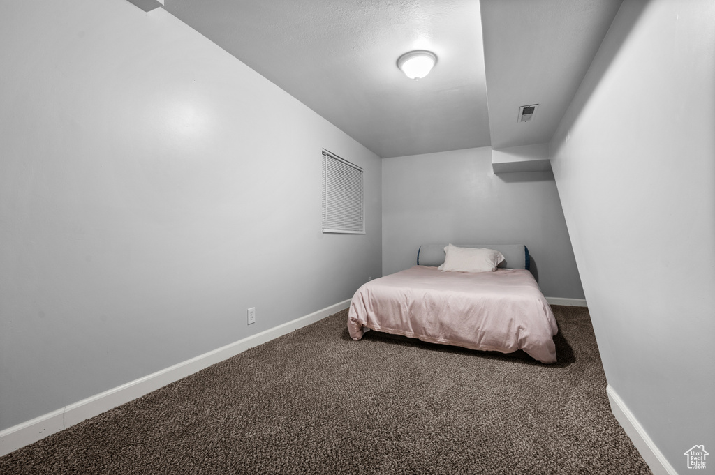 Carpeted bedroom featuring baseboards
