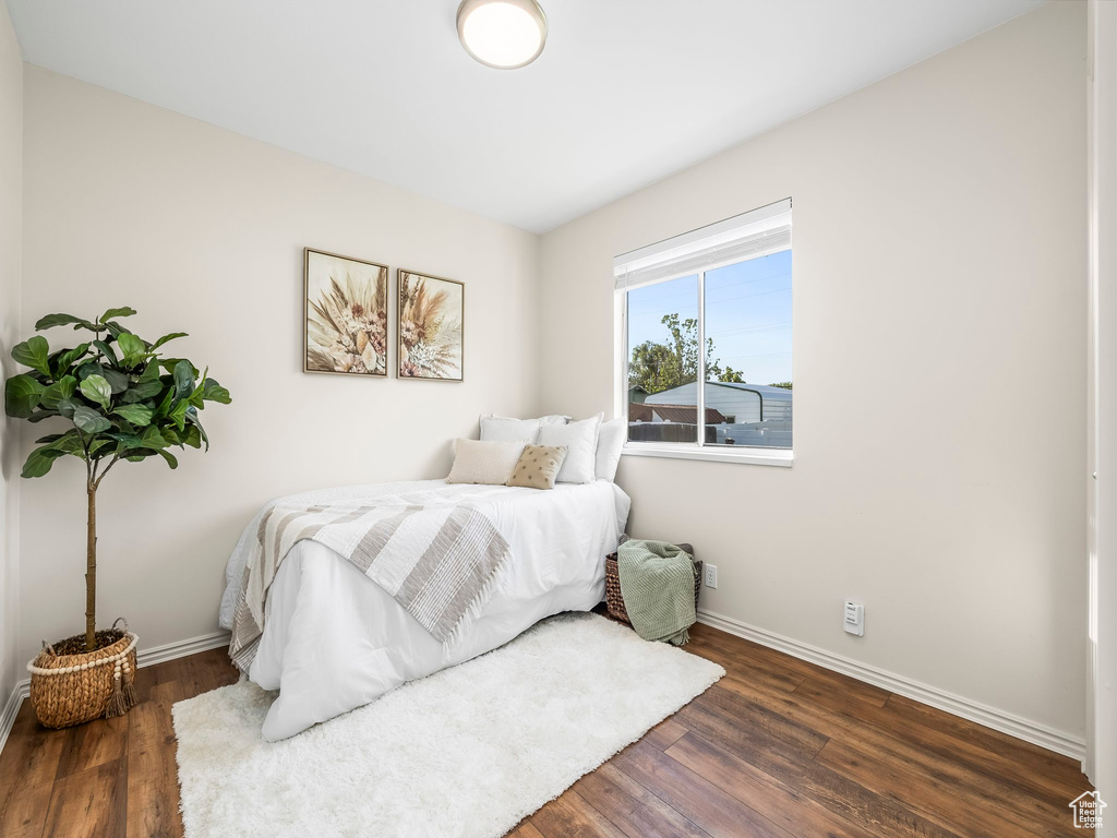 Bedroom with baseboards and wood finished floors