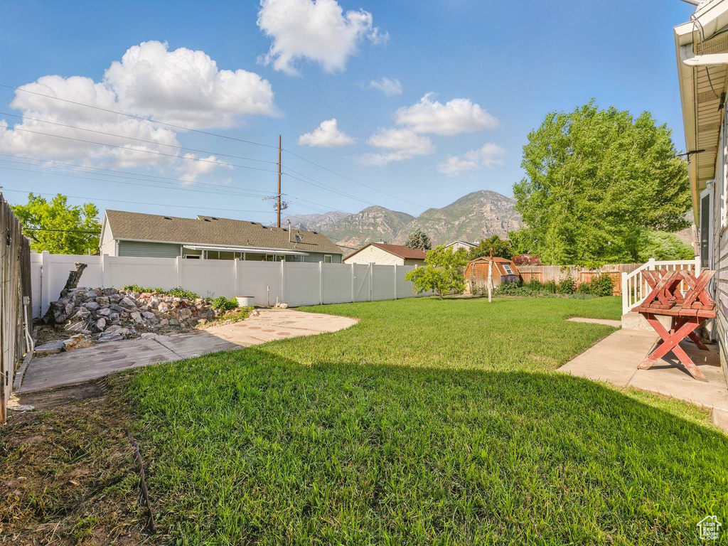 View of yard featuring a mountain view and a patio area